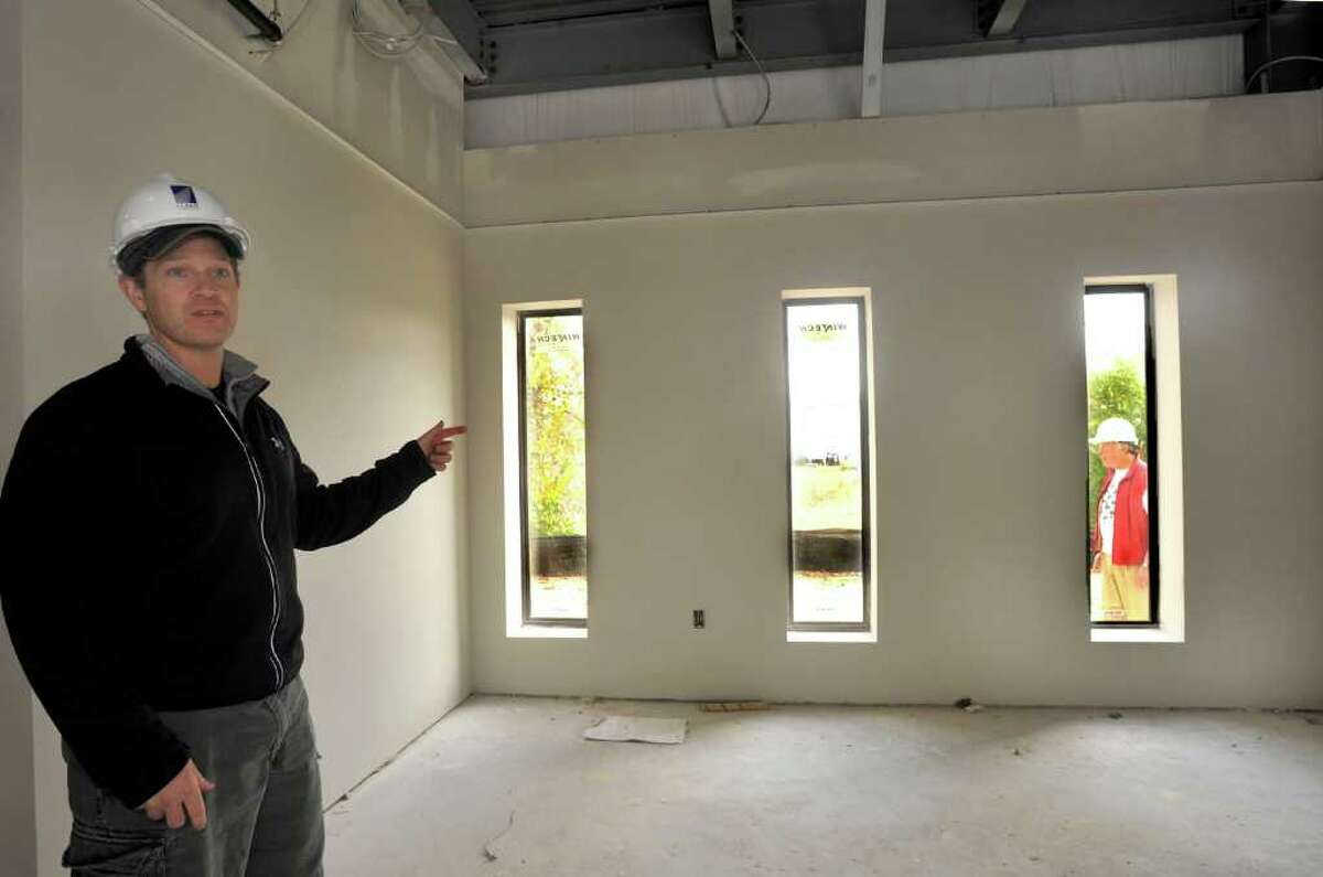 Eric Corson, co-owner and general manager, points out the inside-to-outside feature in the Kid Kare area at the new Phys-Ed Health & Performance fitness center in New Milford, Monday, Oct. 25, 2010.