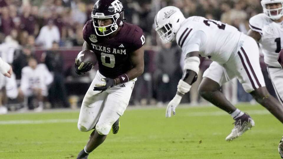 Texas A&M wide receiver Ainias Smith (0) breaks free from a Mississippi State defender for a touchdown during the first half of an NCAA college football game Saturday, Nov. 11, 2023, in College Station, Texas. (AP Photo/Sam Craft)