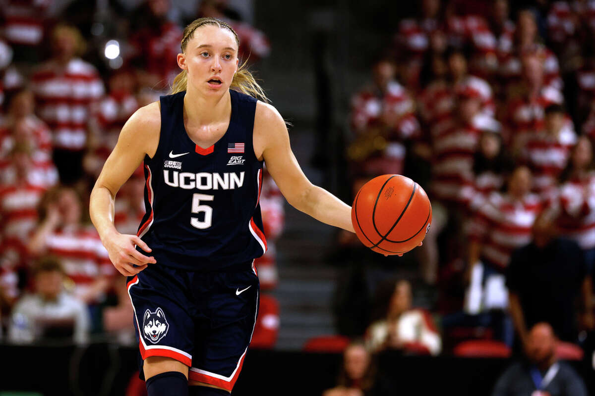 RALEIGH, NORTH CAROLINA - NOVEMBER 12: Paige Bueckers #5 of the UConn Huskies dribbles up court against the NC State Wolfpack during the first half of the game at Reynolds Coliseum on November 12, 2023 in Raleigh, North Carolina. (Photo by Lance King/Getty Images)