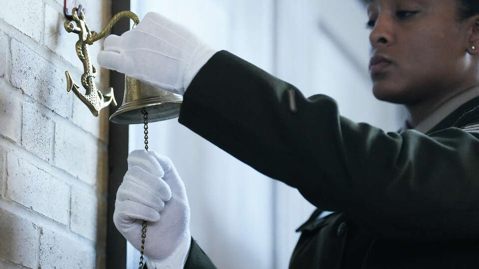 Sgt. Gabriela Corbalan rings a bell as the names of the soldiers from the 3rd Battalion, 24th Infantry Regiment, are read during an event at the Buffalo Soldiers Museum on Monday, Nov. 13, 2023 in Houston.