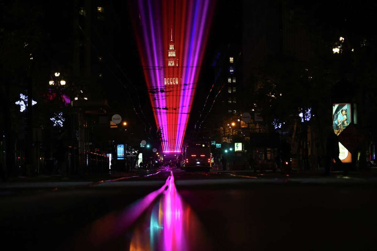 A laser light show over Market Street celebrates APEC in San Francisco on Monday.