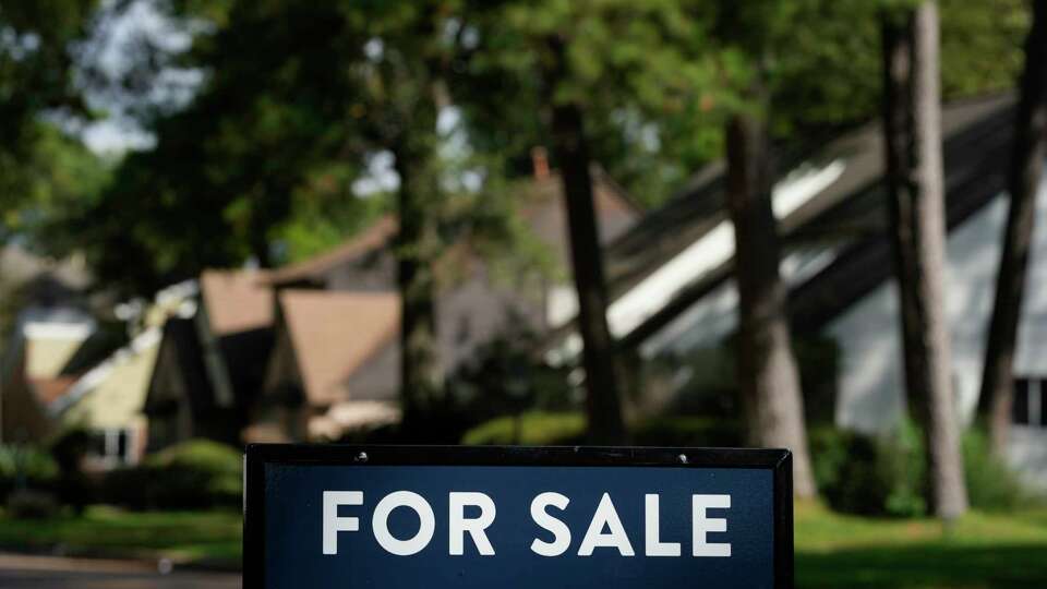 A real estate for sale sign is shown at a home Tuesday, Nov. 14, 2023, in Spring.