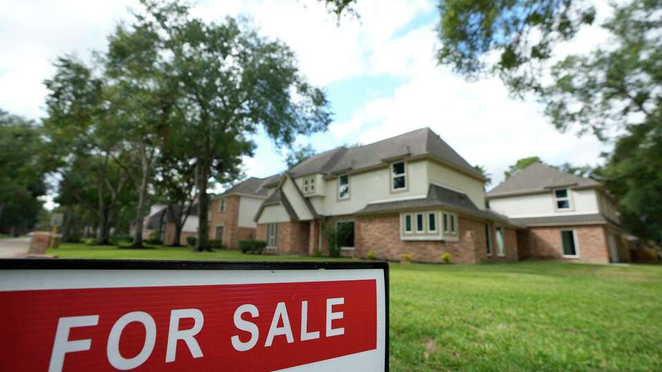 A real estate for sale sign is shown at a home Tuesday, Nov. 14, 2023, in Spring.