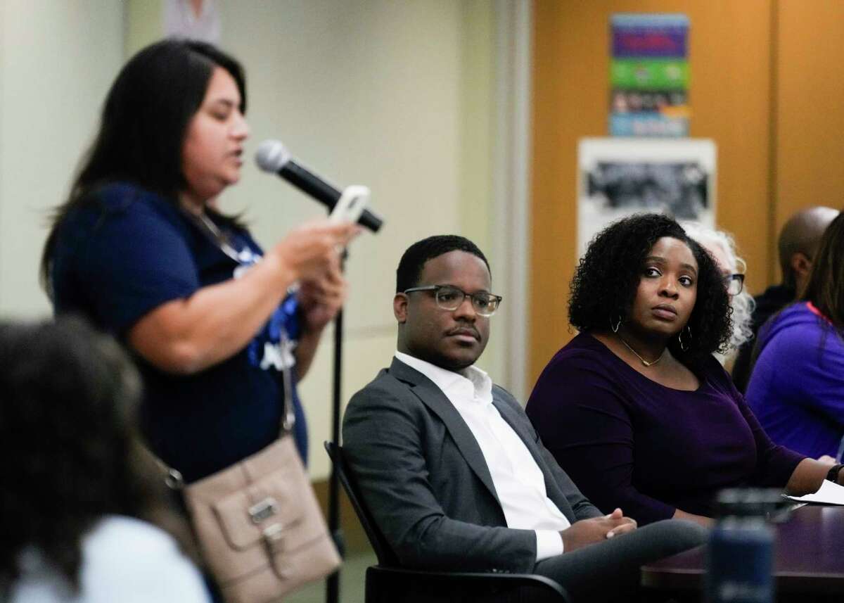 Shayla Bowden, right, listens alongside fellow committee member Kernard Jones as Jessica Campos speaks during the public comment portion as of the Houston ISD's District Advisory Committee meeting at the Hattie Mae White Educational Support Center, Tuesday, Nov. 14, 2023, in Houston. The committee voted to become a District of Innovation, which, if approved by the school board in December, would exempt HISD from several education-related state laws.