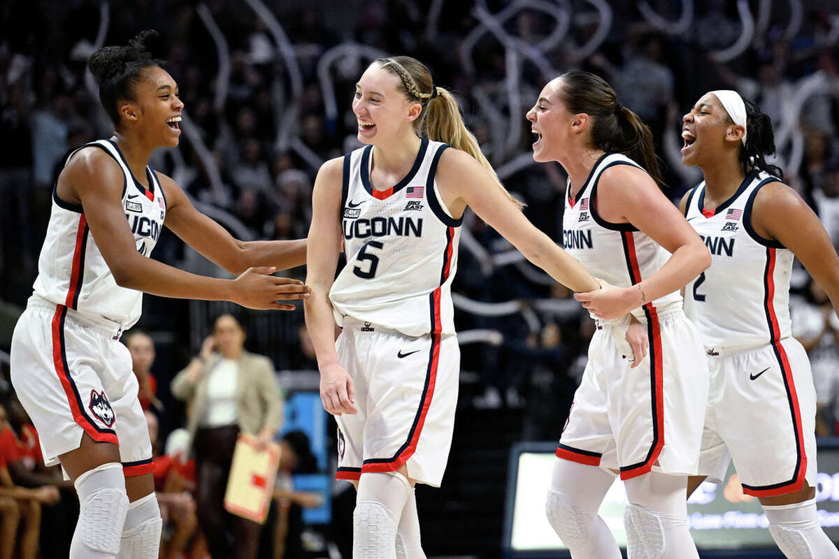 UConn guard Paige Bueckers, center, celebrates with teammates Aubrey Griffin, left, Nika Muhl, second from right, and KK Arnold, right, during the second half of the team's NCAA college basketball game against Maryland, Thursday, Nov. 16, 2023, in Storrs, Conn. (AP Photo/Jessica Hill)