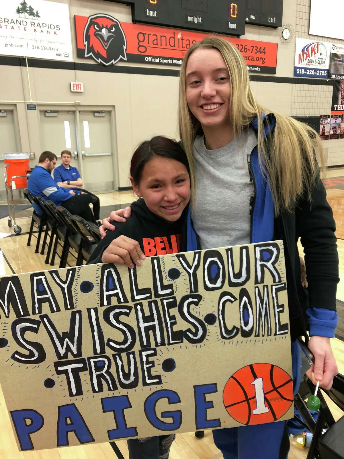 Paige Bueckers after a Hopkins game with a fan who traveled from a nearby city to watch her play. Brian Cosgriff, Bueckers' high school coach, said sometimes hundreds of kids would line up after games just to see Bueckes.