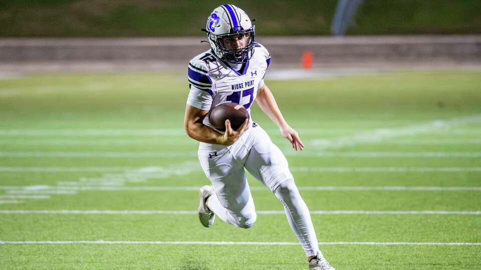 Ridge Point's Austin Carlisle (12) finds running room into the end zone for a touchdown against Lamar in the first half of a high school football game at Delmar Stadium, Friday, Nov. 17, 2023 in Houston.