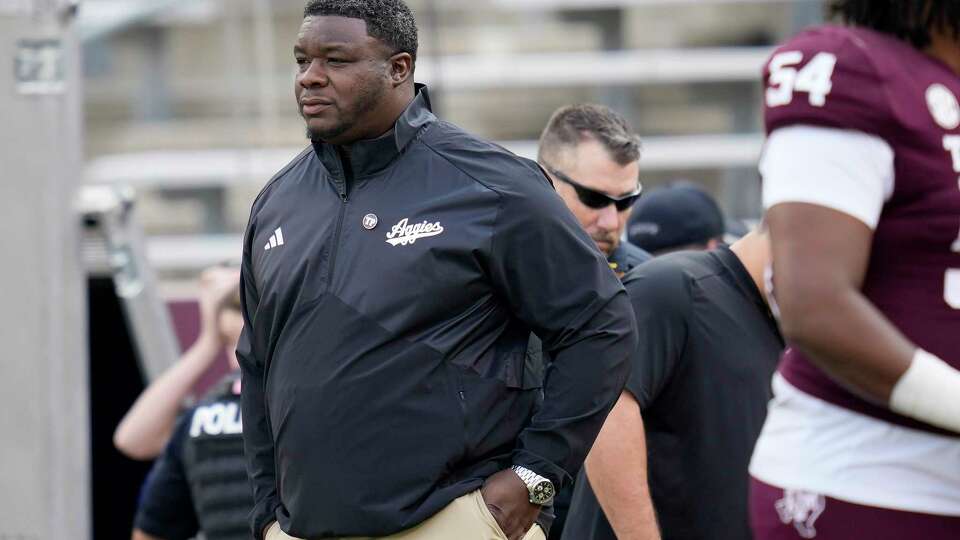 Texas A&M interim head coach Elijah Robinson takes the field for warmups of an NCAA college football game against Abilene Christian on Saturday, Nov. 18, 2023, in College Station, Texas. (AP Photo/Sam Craft)