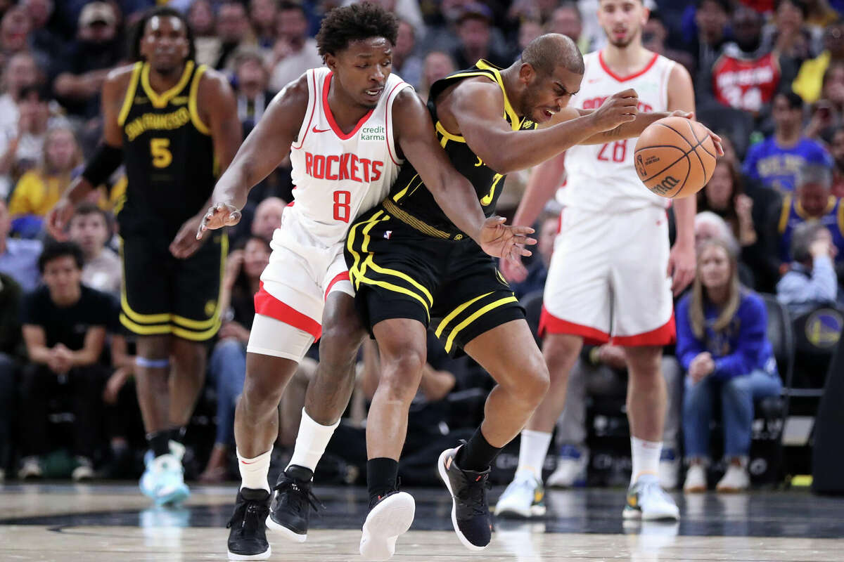 Golden State Warriors' Chris Paul is fouled by Houston Rockets' Jae'Sean Tate during NBA game at Chase Center in San Francisco on Monday, November 20, 2023.