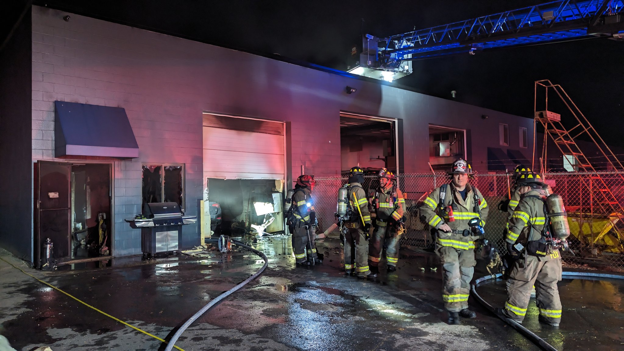 Fire burns car inside building in Newington, officials say