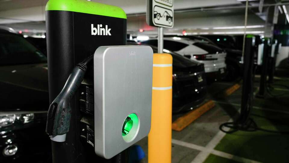 Blink Charging stations for electric vehicles are seen in a parking garage at George Bush Intercontinental Airport, Tuesday, Nov. 21, 2023, in Houston.