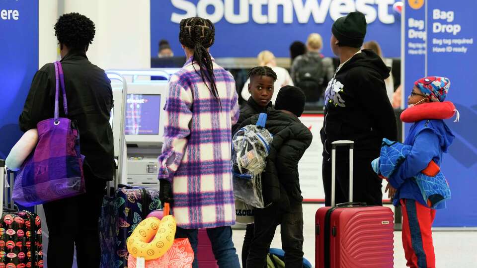 Travelers check in at Southwest Airlines at George Bush Intercontinental Airport, Tuesday, Nov. 21, 2023, in Houston.
