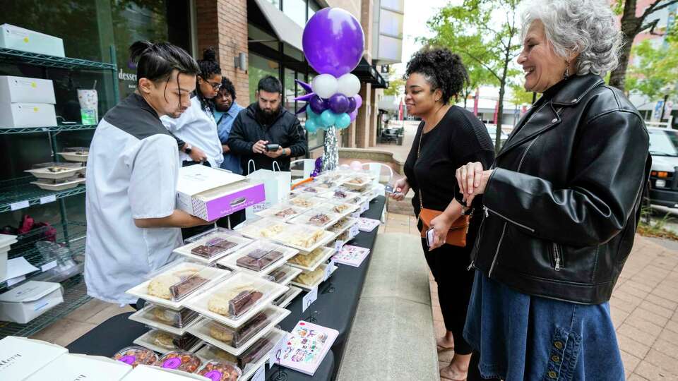 Dessert Gallery owner Sara Brook, right, helps Dianca Holman pick out a selection of pastries during a sneak peek pop-up of the Dessert Gallery's new Waterway Cafe location on Tuesday, Nov. 21, 2023 in The Woodlands.