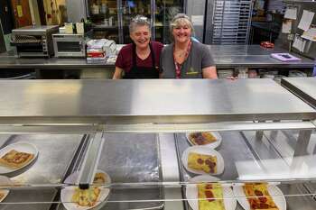 Missy Stanton, left, and Sue Barthelmas work the cafeteria counter at Colonie High School on Tuesday, Nov. 21, 2023, in Colonie, NY.