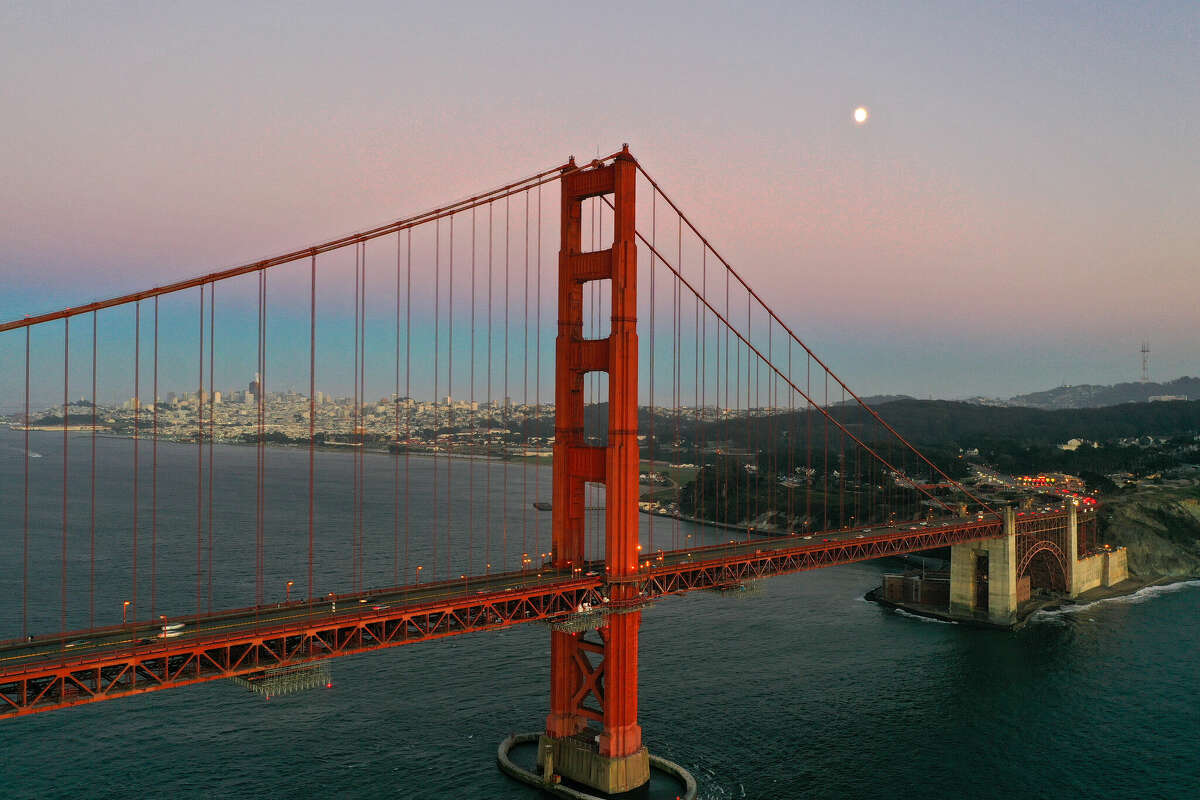 An aerial view of Golden Gate Bridge after sunset from Baker Beach in San Francisco California, United States on August 27, 2023. 