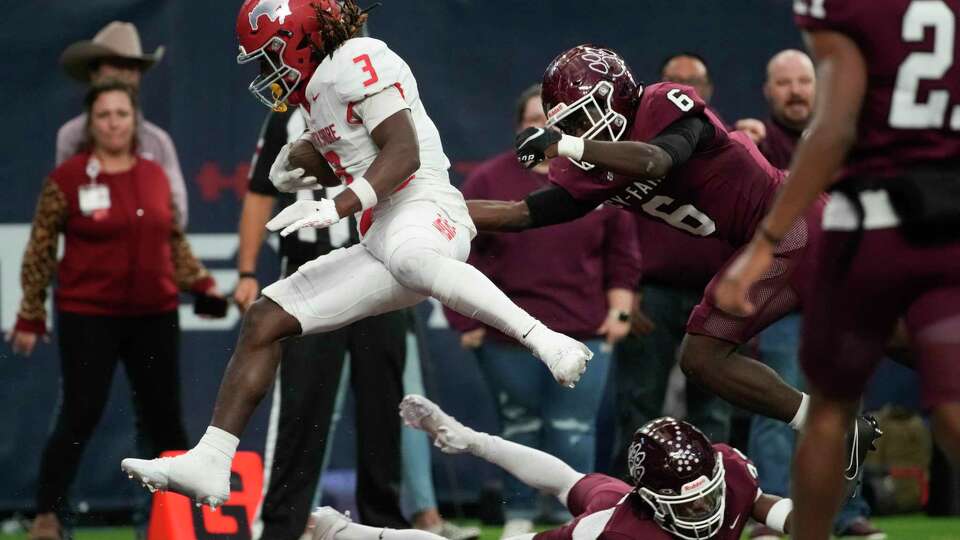 North Shore wide receiver Deion DeBlanc (3) leaps over Cy-Fair cornerback Emmanuel Billings (33) during the second half of a Region III-6A Division 1 semifinal high school football playoff game at NRG Stadium, Friday, Nov. 24, 2023, in Houston.