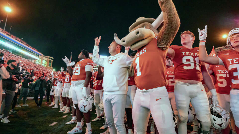 Texas coach Steve Sarkisian sings 'The Eyes of Texas' with team the Bevo mascot after an NCAA college football game against Texas Tech, Friday, Nov. 24, 2023, in Austin, Texas. (AP Photo/Michael Thomas)