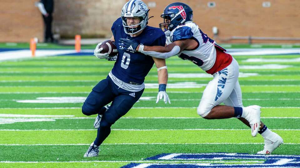 Rice running back Dean Connors (0) fights the tackle of Florida Atlantic linebacker Jackson Ambush (43) as he scrambles for yardage in the second half of a college football game, Saturday, Nov. 25, 2023 at Rice Stadium in. Houston.