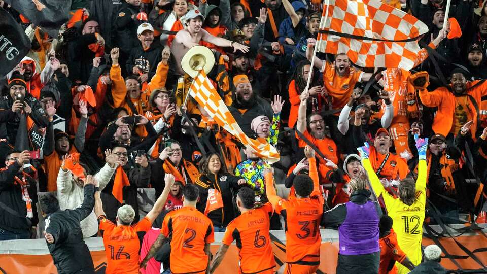 Houston Dynamo fans cheer players celebrating after the Dynamo defeated Sporting Kansas City 1-0 in an MLS Western Conference semifinal soccer match on Sunday, Nov. 26, 2023 in Houston.