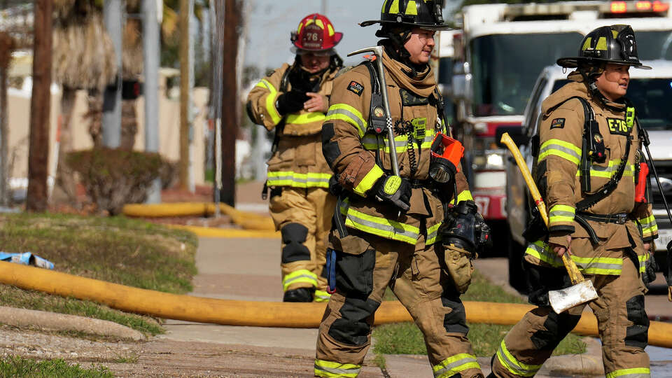 Houston firefighters walking back to the fire trucks after a two-alarm warehouse fire on 12600 block of Bellaire Boulevard is under control on Monday, Nov. 27, 2023 in Houston. No firefighter or civilian were injured in the fire, Houston Fire Department Public Information Officer Sedrick Robinett said.