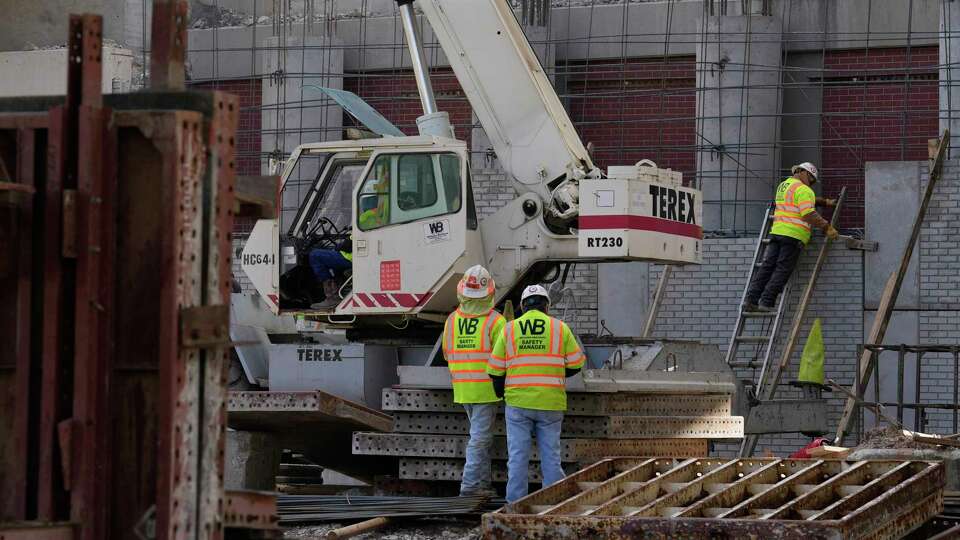 Construction workers working at the site of the Interstate 610 West Loop at Interstate 69 Monday, Nov. 27, 2023 in Houston.