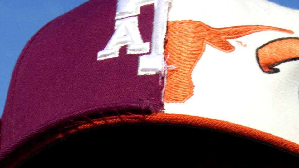 Dr. Geoffrey Garrett, Texas '76, and father of a Texas A&M student, of Shreveport, La., wears the colors of the two longtime rivals before the final scheduled meeting of the schools in an NCAA college football game at Kyle Field Thursday, Nov. 24, 2011, in College Station. ( Brett Coomer / Houston Chronicle )