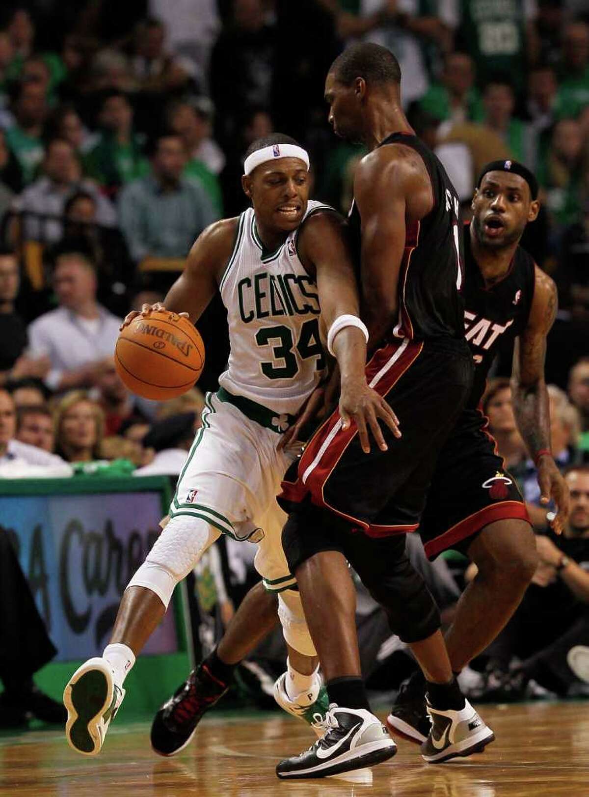 BOSTON, MA - OCTOBER 26: Paul Pierce #34 of the Boston Celtics drives around Chris Bosh #1 and LeBron James #6 of the Miami Heat during a game against the Miami Heat at the TD Banknorth Garden on October 26, 2010 in Boston, Massachusetts. NOTE TO USER: User expressly acknowledges and agrees that, by downloading and or using this photograph, User is consenting to the terms and conditions of the Getty Images License Agreement.(Photo by Jim Rogash/Getty Images) *** Local Caption *** Paul Pierce;Chris Bosh;LeBron James