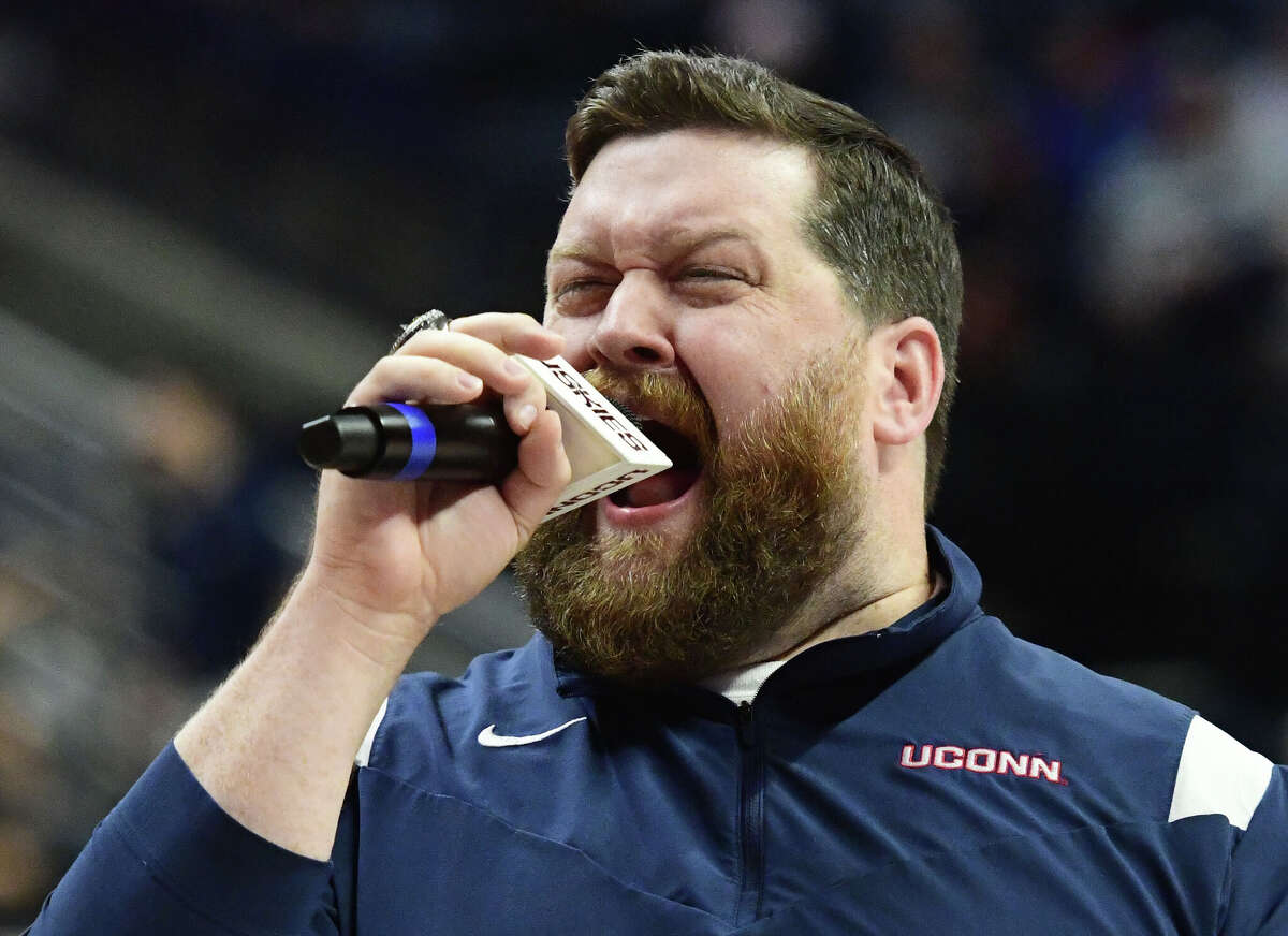 On-court host Conor Geary hypes up the Husky home crowd during UConn's men's basketball game at Gampel Pavilion in Storrs, Conn. Monday, Nov. 27, 2023.