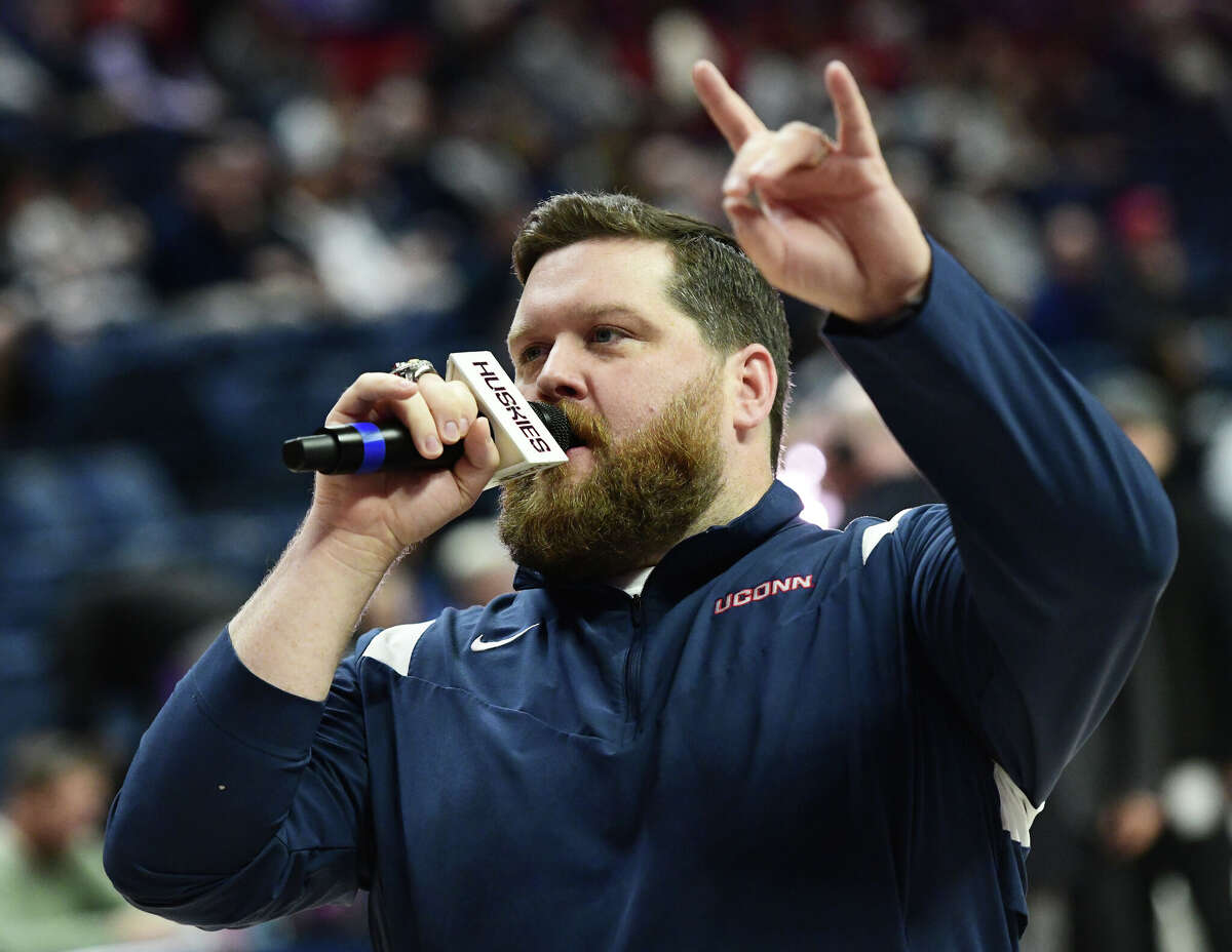 On-court host Conor Geary hypes up the Husky home crowd during UConn's men's basketball game at Gampel Pavilion in Storrs, Conn. Monday, Nov. 27, 2023.
