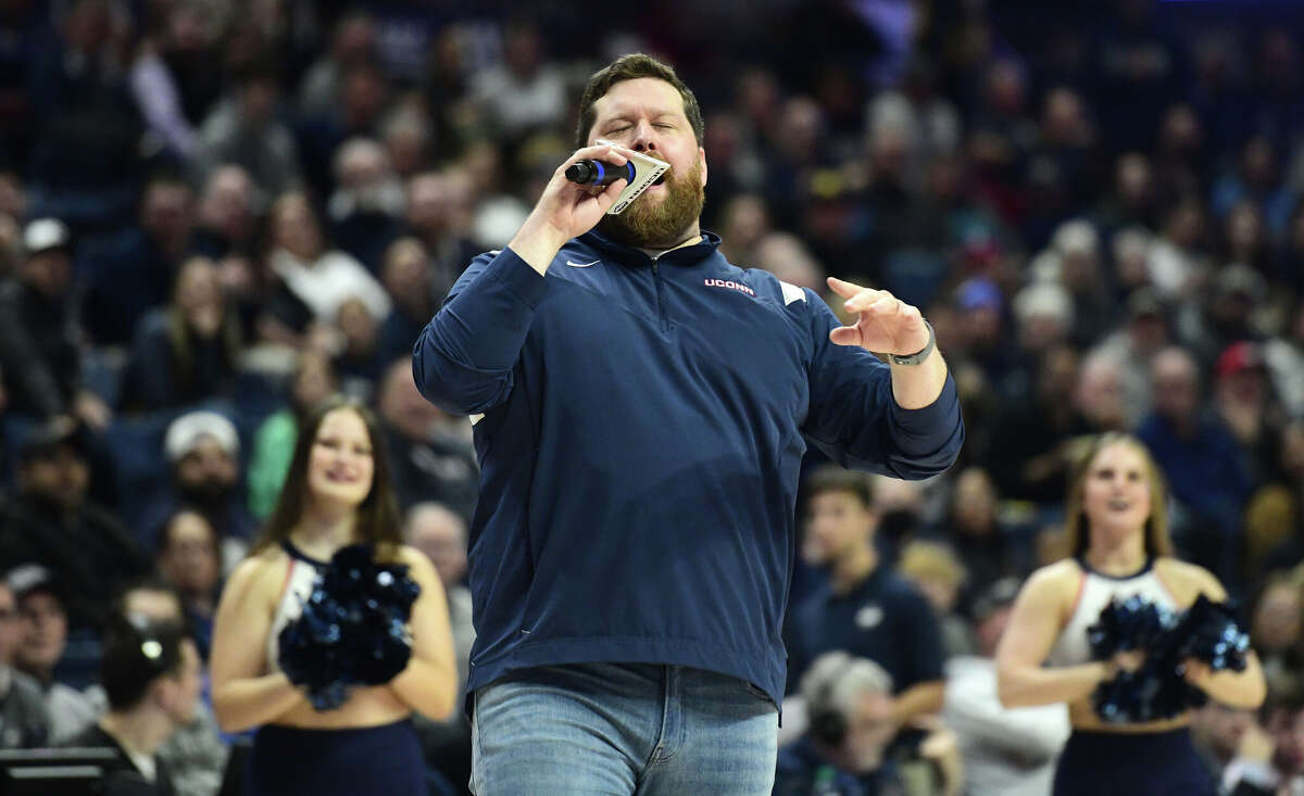 On-court host Conor Geary hypes up the Husky home crowd during UConn's men's basketball game at Gampel Pavilion in Storrs, Conn. Monday, Nov. 27, 2023.