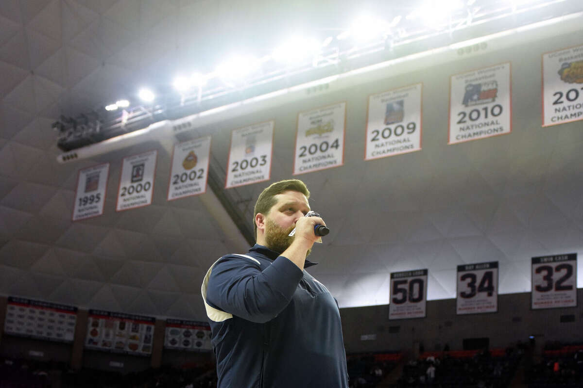 On-court host Conor Geary hypes up the Husky home crowd during UConn's men's basketball game at Gampel Pavilion in Storrs, Conn. Monday, Nov. 27, 2023.