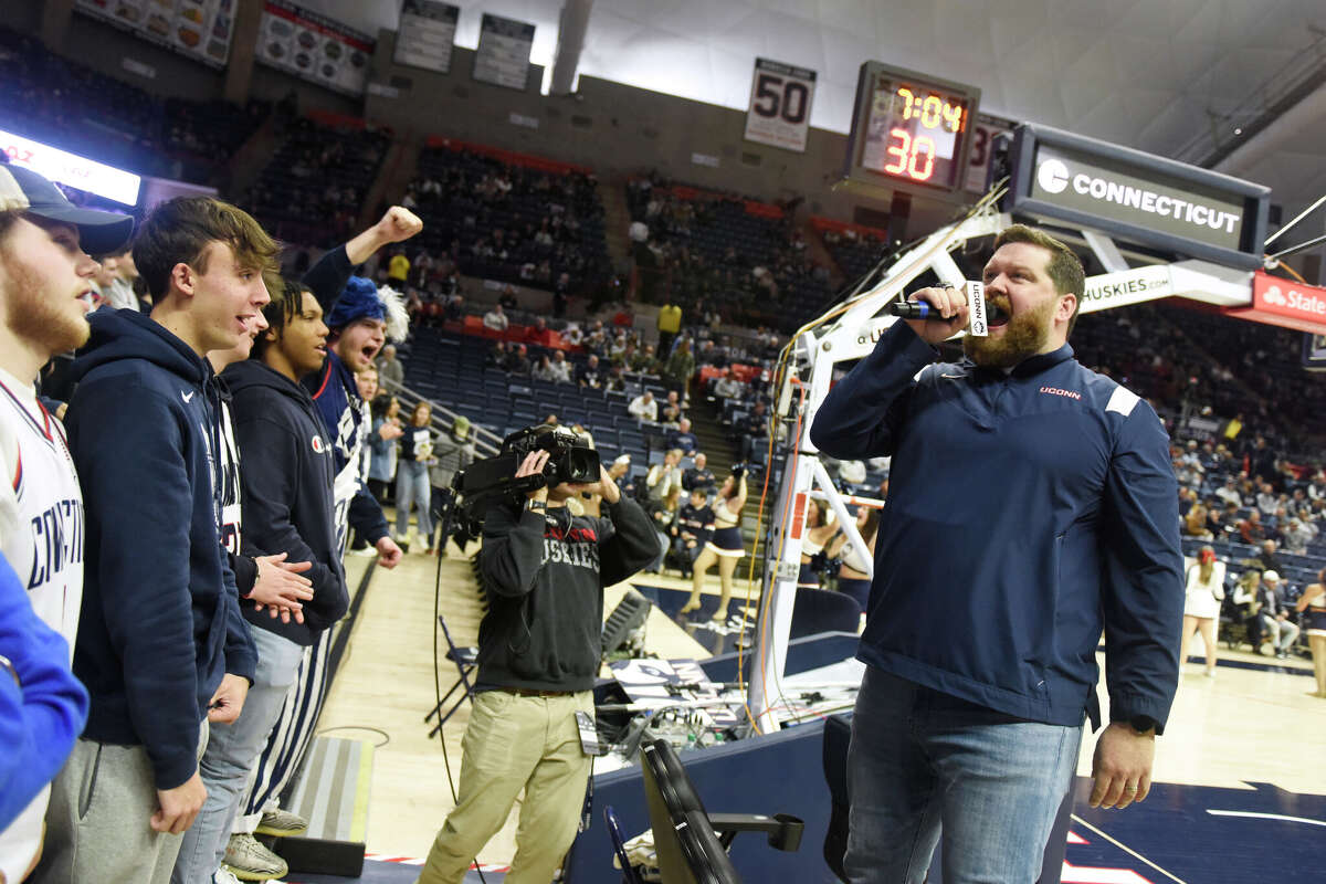 On-court host Conor Geary hypes up the Husky student section during UConn's men's basketball game at Gampel Pavilion in Storrs, Conn. Monday, Nov. 27, 2023.