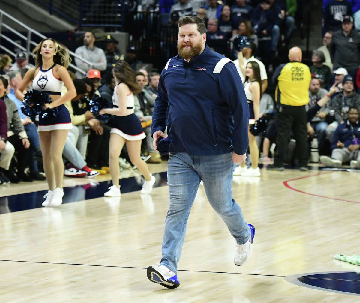 On-court host Conor Geary runs on the court during an intermission in the UConn's men's basketball game at Gampel Pavilion in Storrs, Conn. Monday, Nov. 27, 2023.