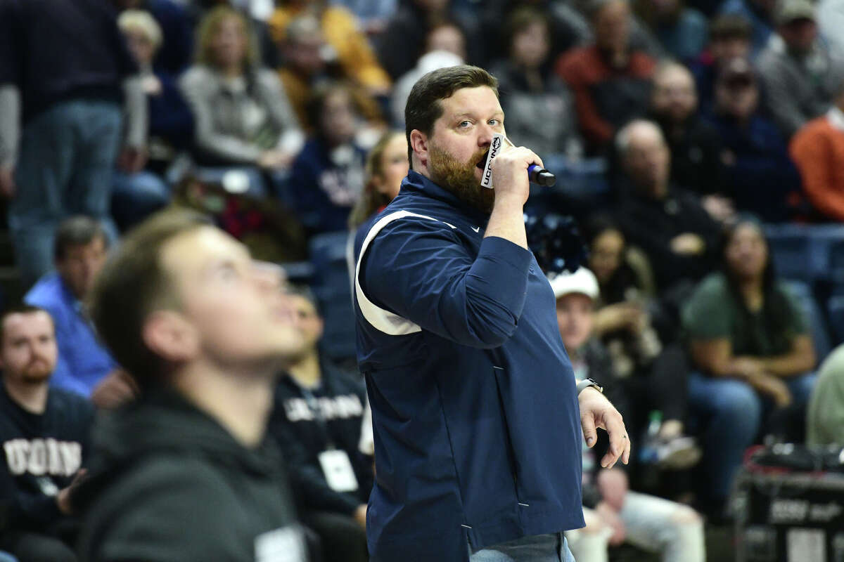 On-court host Conor Geary hypes up the Husky home crowd during UConn's men's basketball game at Gampel Pavilion in Storrs, Conn. Monday, Nov. 27, 2023.