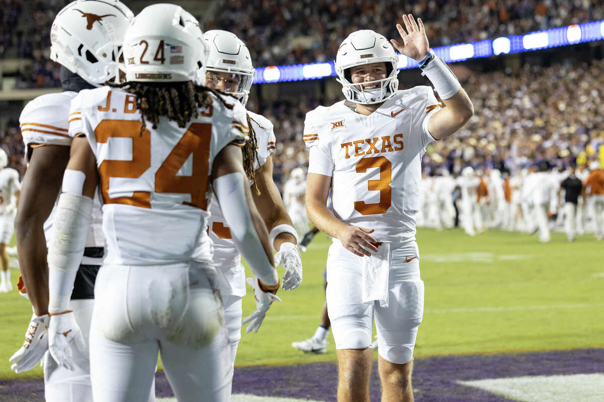 Texas Longhorns quarterback Quinn Ewers (#3) and teammates celebrate a first half touchdown during the college football game between the Texas Longhorns and TCU Horned Frogs on November 11, 2023 at Amon G. Carter Stadium in Fort Worth, TX.