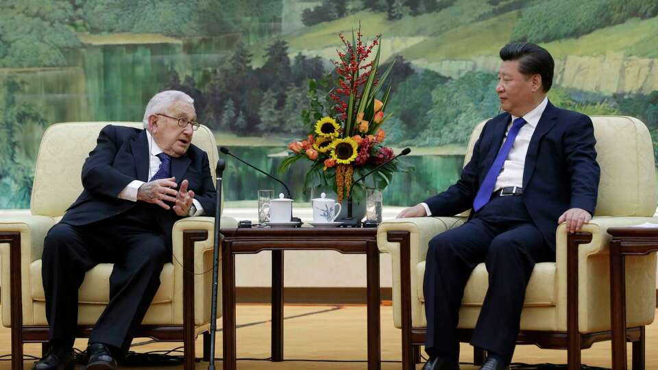 FILE - China's President Xi Jinping, right, listens to former U.S. Secretary of State Henry Kissinger, who led the China-U.S Track Two Dialogue, during a meeting at the Great Hall of the People in Beijing, China, Nov. 2, 2015. Kissinger, the diplomat with the thick glasses and gravelly voice who dominated foreign policy as the United States extricated itself from Vietnam and broke down barriers with China, died Wednesday, Nov. 29, 2023. He was 100. (Jason Lee/Pool Photo via AP, File)