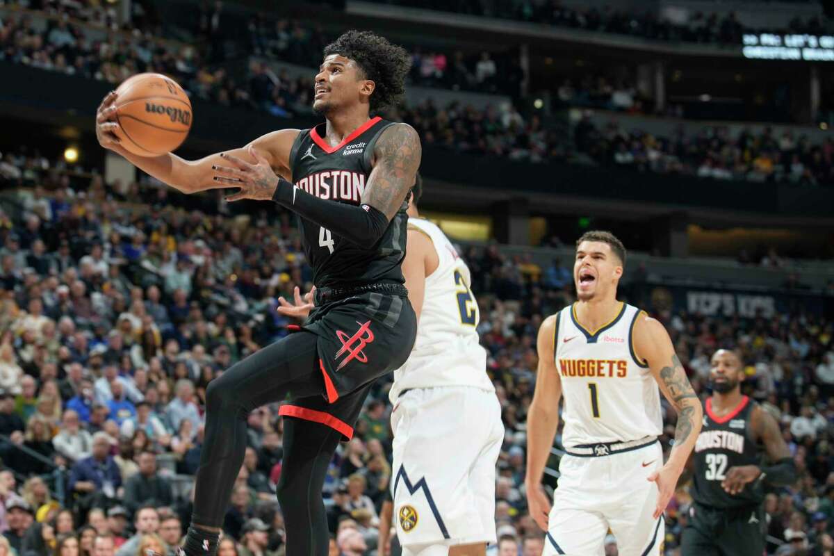 iHouston Rockets guard Jalen Green, left, drives to the rim past Denver Nuggets forwards Zeke Nnaji and Michael Porter Jr. in the second half of an NBA basketball game on Wednesday, Nov. 29, 2023, in Denver. (AP Photo/David Zalubowski)