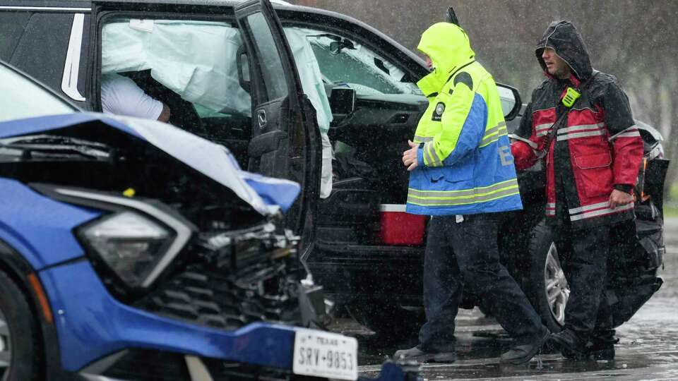 The Woodlands Fire Department and EMS with the Montgomery County Hospital District respond to a two-vehicle accident that caused both airbags to deploy in steady rain at St. Lukes Way and east-bound Texas 242, Thursday, Nov. 30, 2023, in The Woodlands.