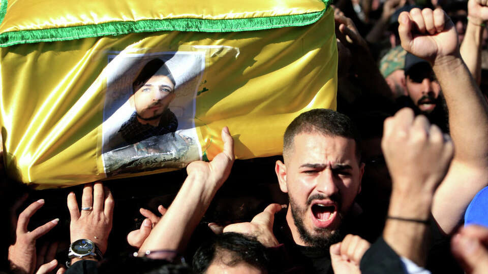 Mourners carry the casket of Hezbollah fighter Youssef Karam Jawad, killed during cross-border clashes with Israel on November 24. 