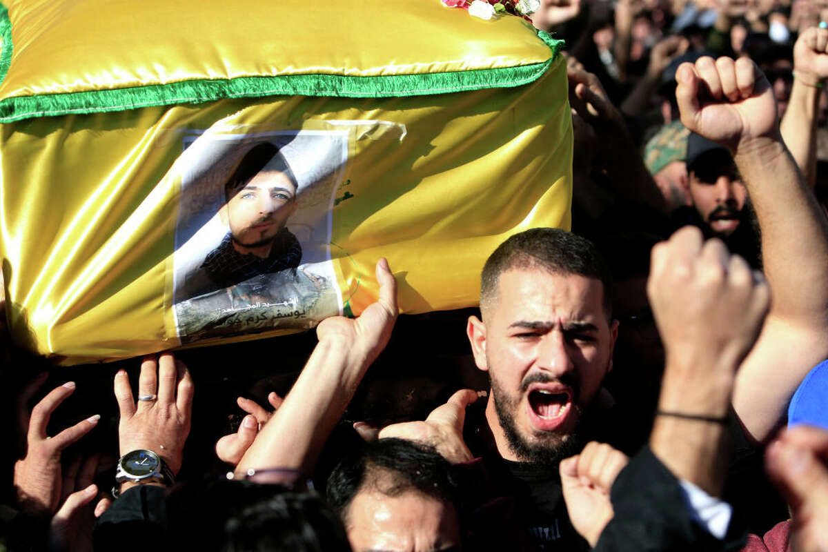 Mourners carry the casket of Hezbollah fighter Youssef Karam Jawad, killed during cross-border clashes with Israel on November 24. 