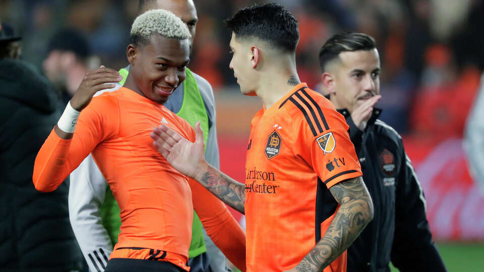 Houston Dynamo's, from left, Nelson Quinones, Franco Escobar and Amine Bassi celebrate their 1-0 win over Sporting Kansas City after an MLS playoff soccer match Sunday, Nov. 26, 2023, in Houston. (AP Photo/Michael Wyke)