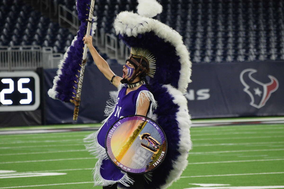 The 'Indian Spirit' mascot of Port Neches-Groves takes part in a ritual prior to a Texas high school football playoff game, Friday, Dec. 1, at NRG Stadium in Houston.