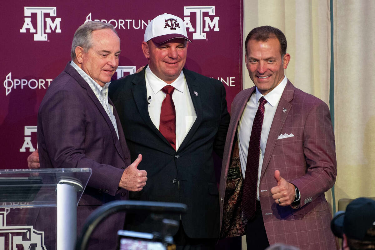 New Texas A&M coach Mike Elko, with athletic director Ross Bjork (right) and school president Mark Welsh (left), takes over an Aggies program with the clear expectation to win now, not years down the road, in the SEC with Texas and Oklahoma arriving next season.