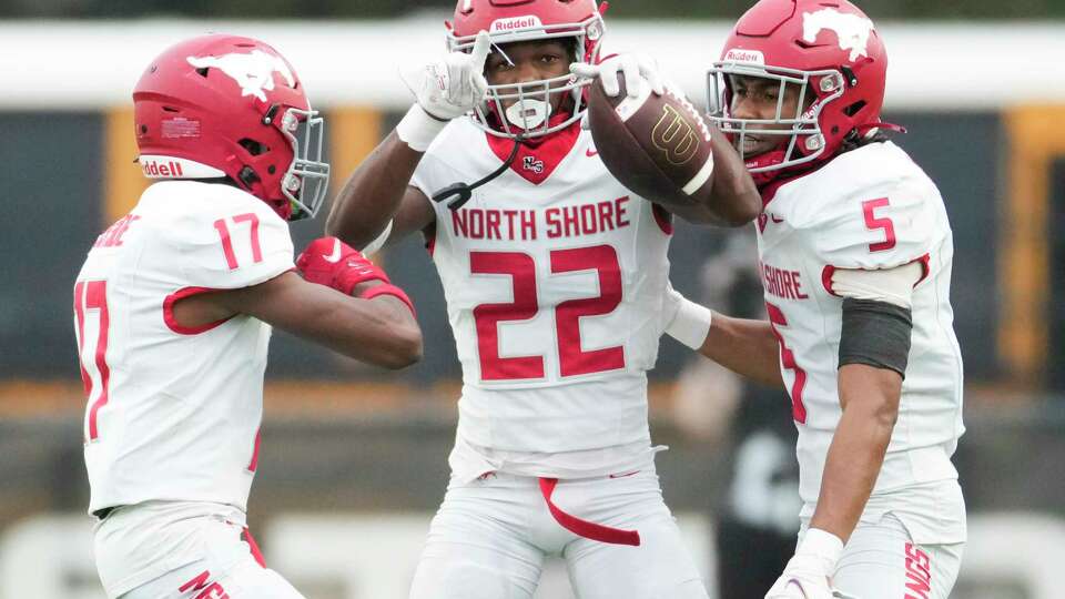 North Shore defensive back Khamani Hudson (22) celebrates alongside free safety Paul Porter (17) and cornerback Lavonte Johnson (5) after intercepting a pass intended for Atascocita wide receiver Jelani Watkins during the second half of the Region III-6A Division II championship at Pasadena Veterans Memorial Stadium, Saturday, Dec. 2, 2023, in Pasadena.