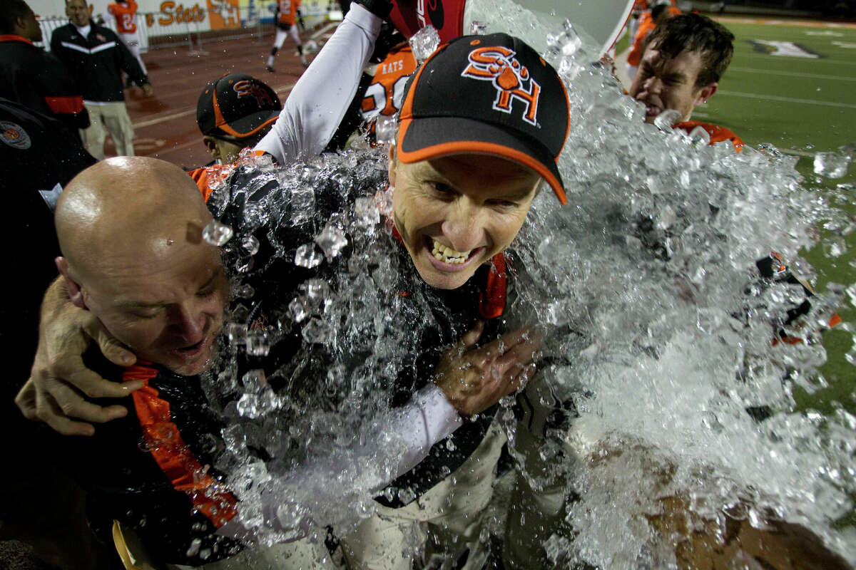 Sam Houston State head coach WIllie Fritz, center, is dunked by a bucket of ice water after the Bearkats beat Montana in the NCAA Football Championship Subdivision semifinal playoff game at Bowers Stadium Friday, Dec. 16, 2011, in Huntsville, Texas. Sam Houston beat Montana 31-28 to advance to the FCS championship game.