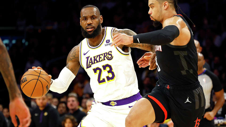 LOS ANGELES, CALIFORNIA - DECEMBER 02: LeBron James #23 of the Los Angeles Lakers controls the ball against Dillon Brooks #9 of the Houston Rockets in the first quarter at Crypto.com Arena on December 02, 2023 in Los Angeles, California. NOTE TO USER: User expressly acknowledges and agrees that, by downloading and/or using this photograph, user is consenting to the terms and conditions of the Getty Images License Agreement. (Photo by Ronald Martinez/Getty Images)