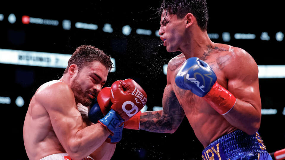 Ryan Garcia exchanges punches with Oscar Duarte during their welterweight fight at Toyota Center on December 2, 2023 in Houston, Texas.