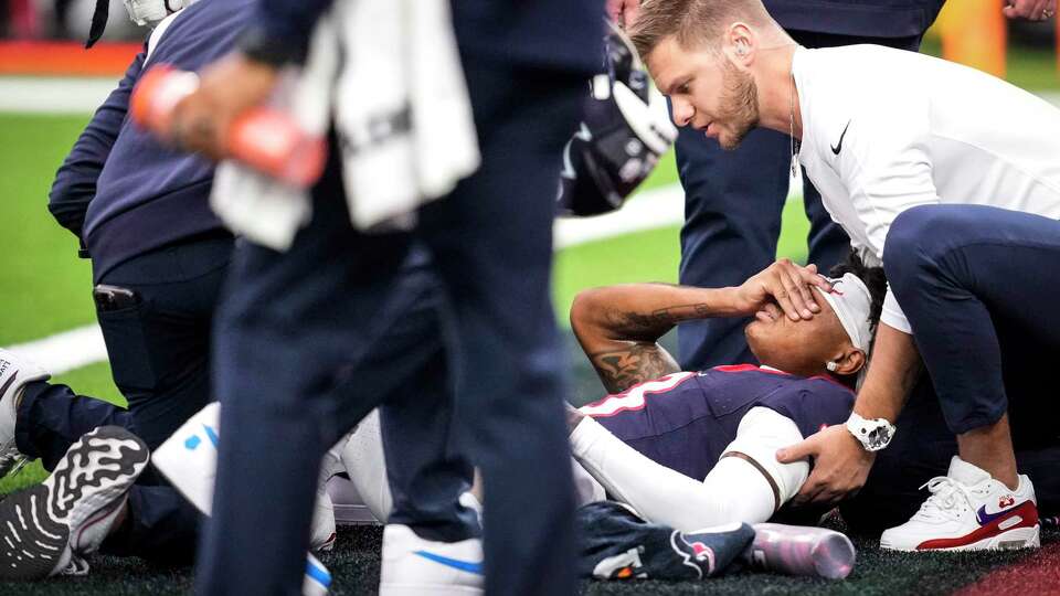 Houston Texans wide receiver Tank Dell (3) is tended to by the training staff after suffering a leg injury during the first half of an NFL football game against the Denver Broncos Sunday, Dec. 3, 2023, in Houston.