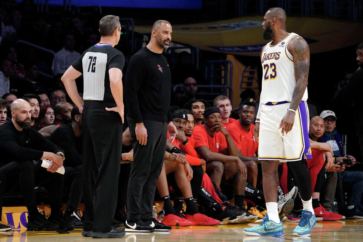 Houston Rockets head coach About Ime Udoka, center, and Los Angeles Lakers forward LeBron James, right, exchange words during the second half of an NBA basketball game as referee J.T. Orr watches Saturday, Dec. 2, 2023, in Los Angeles. James and Udoka both received technical fouls soon after and Udoka was ejected from the game as that was his second technical foul. 