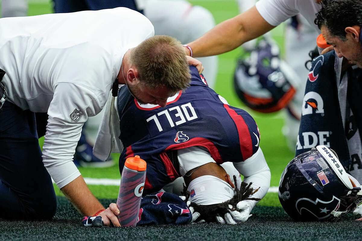 Tank Dell #3 of the Houston Texans is attended to after being injured in the first quarter against the Denver Broncos at NRG Stadium on December 03, 2023 in Houston, Texas. 